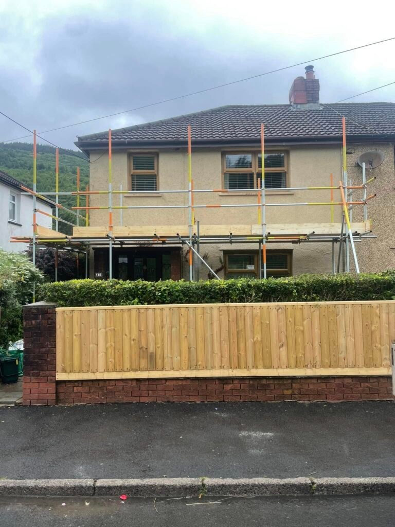 Scaffolding with guardrails on a semi-detached house