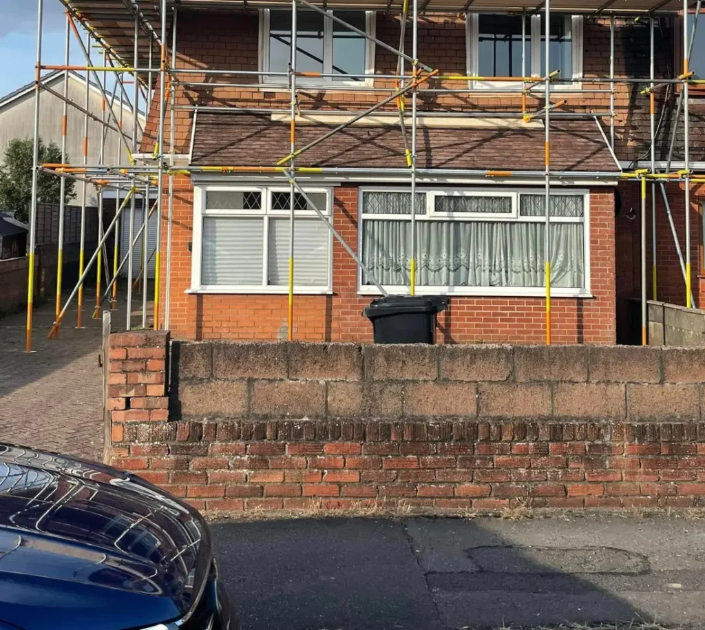 Inspected domestic scaffold with boarded lifts and guardrails in South Wales